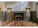 Cozy living room showcases fireplace, wood-look floors, decorative molding, and natural light at 600 S Cline Ave, Newton, NC 28658
