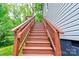 Exterior staircase leads to the house with wooden railing and green trees in the background at 600 S Cline Ave, Newton, NC 28658