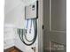 Utility room boasts modern water heater with stainless steel fixtures and custom shelving at 600 S Cline Ave, Newton, NC 28658