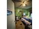 Modest bedroom featuring a ceiling fan, dated decor, and a person lying on the bed at 618 Douglas St, Shelby, NC 28150
