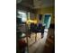 A cluttered kitchen featuring a dining table, cabinets, and a window at 618 Douglas St, Shelby, NC 28150
