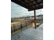 Wooden patio deck with a string lights overlooking the backyard with a iron fence at 664 Cape Fear St, Fort Mill, SC 29715
