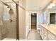 Bright bathroom featuring a walk-in shower, vanity, and an open doorway to a walk in closet at 664 Cape Fear St, Fort Mill, SC 29715