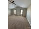 Spacious bedroom with vaulted ceiling, two windows, neutral carpet, and gray walls at 664 Cape Fear St, Fort Mill, SC 29715