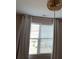 Bedroom with beaded chandelier and white curtains filtering light through window blinds at 664 Cape Fear St, Fort Mill, SC 29715