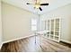 Bright bedroom with wood flooring, a ceiling fan, and a white shelving unit with a desk at 664 Cape Fear St, Fort Mill, SC 29715