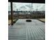 Wooden patio deck with a fire pit, string lights and a backyard view of the neighborhood at 664 Cape Fear St, Fort Mill, SC 29715