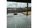 Wooden patio deck with a fire pit, string lights and a backyard view of the neighborhood at 664 Cape Fear St, Fort Mill, SC 29715