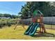 Backyard playground equipment featuring two slides, a tic-tac-toe game, and a swing set at 664 Cape Fear St, Fort Mill, SC 29715