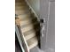 A carpeted staircase is adjacent to a door with an digital handle at 664 Cape Fear St, Fort Mill, SC 29715