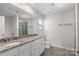Bright bathroom featuring a double vanity with granite countertop and modern fixtures at 687 Cape Fear St, Fort Mill, SC 29715