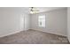 Bright bedroom features a neutral walls, plush carpet, and large window, creating a comfortable retreat at 687 Cape Fear St, Fort Mill, SC 29715