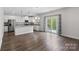 Open kitchen features white cabinets, stainless appliances, and plenty of countertop space at 687 Cape Fear St, Fort Mill, SC 29715