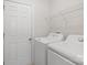 Convenient laundry room equipped with a washer, dryer, and storage shelving at 687 Cape Fear St, Fort Mill, SC 29715