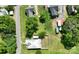Aerial view showcasing the property's layout, neighborhood, backyard with fence, and proximity to nearby homes at 711 Wood St, Albemarle, NC 28001