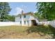 Backyard view features a white fence, staircase, and potential for outdoor living at 711 Wood St, Albemarle, NC 28001