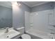 This bathroom has a tub and shower combination with a white vanity and neutral walls at 711 Wood St, Albemarle, NC 28001