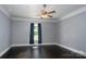 This spacious bedroom features hardwood floors, a ceiling fan, and a window for natural light at 711 Wood St, Albemarle, NC 28001