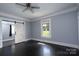 Bright bedroom featuring dark wood floors, natural light, and a barn door closet at 711 Wood St, Albemarle, NC 28001