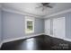 Bright bedroom featuring dark wood floors, natural light, and a ceiling fan at 711 Wood St, Albemarle, NC 28001