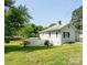 This home has a white exterior with a spacious yard at 711 Wood St, Albemarle, NC 28001