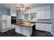 Well-lit kitchen with an island, modern appliances, and ample cabinet space at 711 Wood St, Albemarle, NC 28001