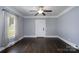 Bright living room featuring dark wood floors, natural light, a ceiling fan, and grey walls at 711 Wood St, Albemarle, NC 28001