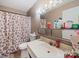 This bathroom has a white sink, mirror, and gingerbread shower curtain at 7977 Shady Oak Trl, Charlotte, NC 28210