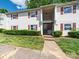 Charming condo with red shutters, well-maintained lawn, and easy access stairs to the front door at 7977 Shady Oak Trl, Charlotte, NC 28210