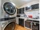 View of kitchen and side-by-side washer dryer, featuring white cabinets and tile backsplash at 7977 Shady Oak Trl, Charlotte, NC 28210