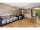 Spacious living room with laminate floors and access to the dining area at 7977 Shady Oak Trl, Charlotte, NC 28210
