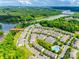 Community aerial featuring manicured lawns, a river, mature trees, swimming pool, and residential homes at 809 River Park Rd, Belmont, NC 28012