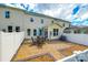 View of back of the home with patio, table, chairs, umbrella, and white fence at 809 River Park Rd, Belmont, NC 28012