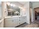 Luxurious bathroom featuring double sinks, a large mirror, and a door to the shower at 809 River Park Rd, Belmont, NC 28012