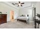 Comfortable bedroom with tray ceiling features a bed with elegant bedding and carpeted floors at 809 River Park Rd, Belmont, NC 28012