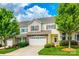 Charming two-story townhome featuring a two car garage, stone accents, and manicured lawn at 809 River Park Rd, Belmont, NC 28012