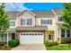 Inviting two-story townhouse featuring a stone facade and attached two-car garage at 809 River Park Rd, Belmont, NC 28012