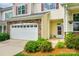 Two-story townhouse with a beige facade, stone accents, and a well-manicured lawn at 809 River Park Rd, Belmont, NC 28012