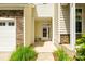 Townhouse front door with stone accents and adjacent two-car garage at 809 River Park Rd, Belmont, NC 28012