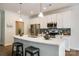 Modern kitchen with white cabinetry, stainless steel appliances, and breakfast bar at 809 River Park Rd, Belmont, NC 28012