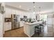 Bright, open kitchen with stainless steel appliances and a spacious island with seating at 809 River Park Rd, Belmont, NC 28012