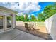 Inviting patio with outdoor seating, umbrella, and a white fence overlooking lush greenery at 809 River Park Rd, Belmont, NC 28012