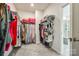 Organized walk-in closet with carpeted floors, clothing racks, and shelving for optimal storage at 809 River Park Rd, Belmont, NC 28012
