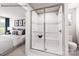 Ensuite bathroom with a glass-enclosed shower featuring tiled walls and a seat and a bedroom view at 964 Pemberley St # 3193, Lancaster, SC 29720