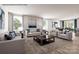 Spacious living room featuring modern furniture, large windows with natural light, and a dining area in view at 964 Pemberley St # 3193, Lancaster, SC 29720