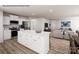 Open-concept living space with a kitchen island, stainless appliances, and an adjacent living area with stylish furniture at 964 Pemberley St # 3193, Lancaster, SC 29720