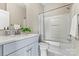Well-lit bathroom featuring marble floors and a shower-tub combination with a white shower curtain at 110 Dime Ln, Mooresville, NC 28117