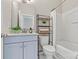 Cozy bathroom featuring granite countertops, a metal storage shelf and a shower-tub combination at 110 Dime Ln, Mooresville, NC 28117