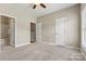 Neutral bedroom featuring plush carpeting, a ceiling fan and two access doors providing ample closet space at 110 Dime Ln, Mooresville, NC 28117