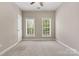 Neutral bedroom featuring plush carpeting, a ceiling fan and two windows providing lots of natural light at 110 Dime Ln, Mooresville, NC 28117